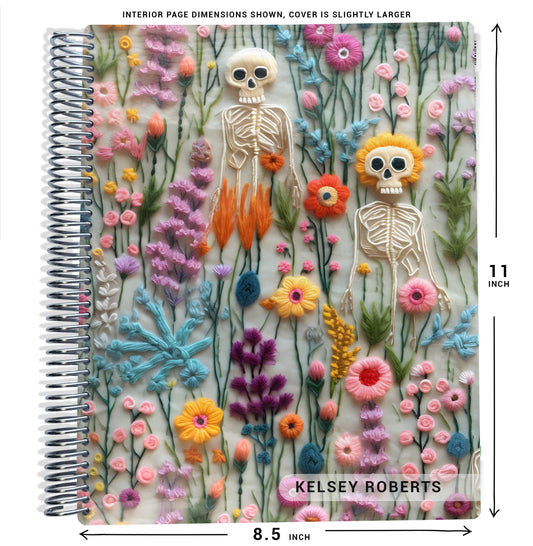pink, purple, and blue skeleton and flower illustrations, on planner Notebook with spiral binding on a white background with size dimensions