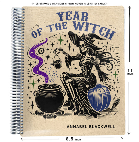 Notebook with beige background, text that says 'year of the witch', and a illustration of a witch and cauldron design, size dimensions shown