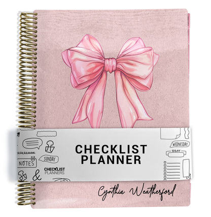planner Notebook with a pink bow design on a pink background cover