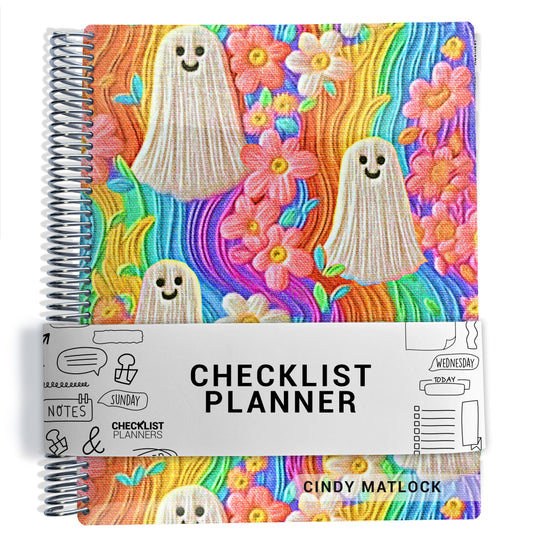 a colorful spiral-bound planner with a whimsical, ghost-like design on the cover.