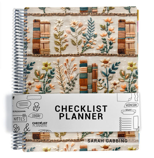 fake embroidered books and green flowers pattern on planner Notebook with spiral binding on a white background