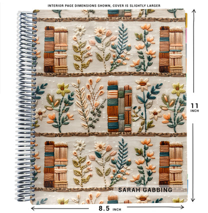 fake embroidered books and green flowers pattern on planner Notebook with spiral binding and size dimensions labeled on a white background